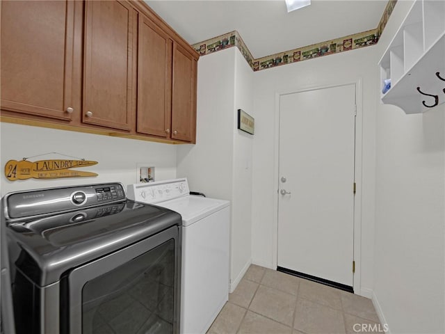 20361 Julia Ln, Saugus, CA 91350 - laundry area with separate washer and dryer, cabinet space, light tile patterned flooring, and baseboards