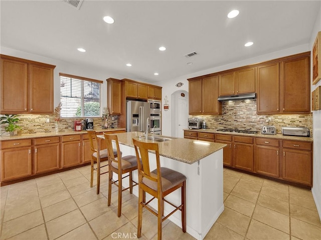 20361 Julia Ln, Saugus, CA 91350 - kitchen featuring stainless steel appliances, brown cabinetry, a sink, and recessed lighting