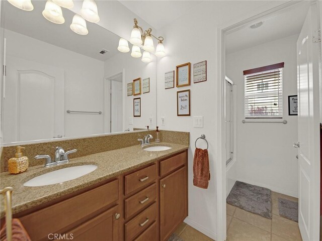 20361 Julia Ln, Saugus, CA 91350 - bathroom featuring double vanity, tile patterned floors, enclosed tub / shower combo, and baseboards