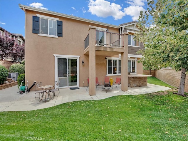 20361 Julia Ln, Saugus, CA 91350 - rear view of property featuring a balcony, a fire pit, stucco siding, a patio area, and central AC unit