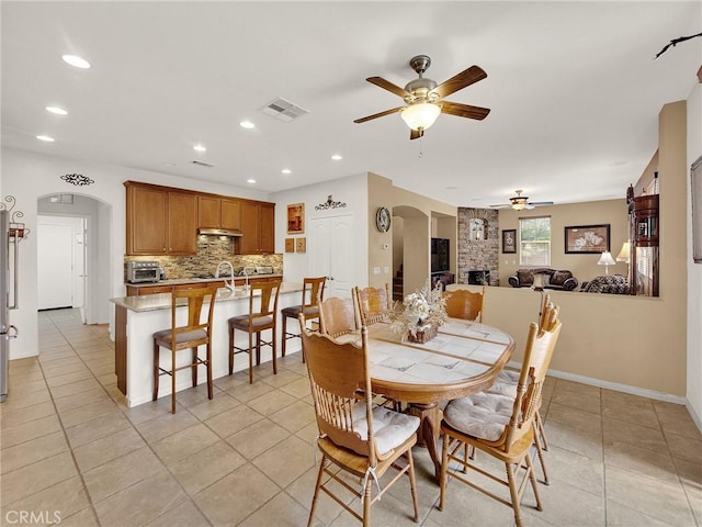 20361 Julia Ln, Saugus, CA 91350 - dining room with arched walkways, a ceiling fan, recessed lighting, baseboards, and light tile patterned floors