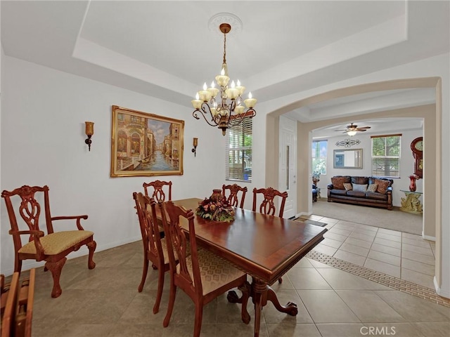 20361 Julia Ln, Saugus, CA 91350 - tiled dining room featuring a raised ceiling, arched walkways, a chandelier, and baseboards