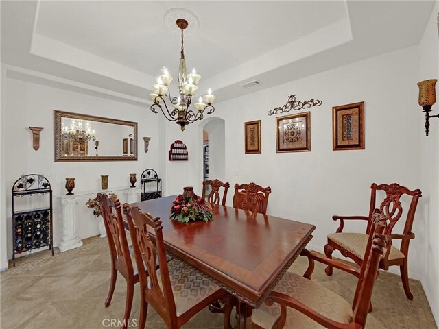 20361 Julia Ln, Saugus, CA 91350 - dining room featuring arched walkways, a tray ceiling, and a chandelier
