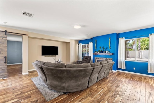 35616 Suzette Ct, Winchester, CA 92596 - living area with a barn door, baseboards, and wood finished floors
