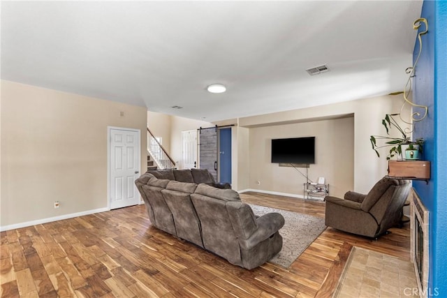 35616 Suzette Ct, Winchester, CA 92596 - living room with wood finished floors, a barn door, baseboards, and stairs