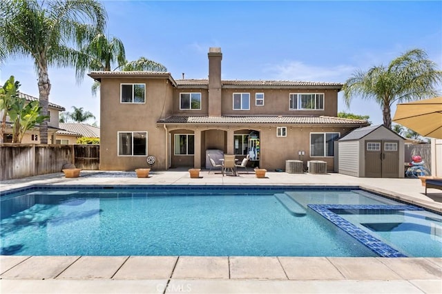 35616 Suzette Ct, Winchester, CA 92596 - back of property featuring a chimney, a patio area, central air condition unit, a fenced backyard, and stucco siding