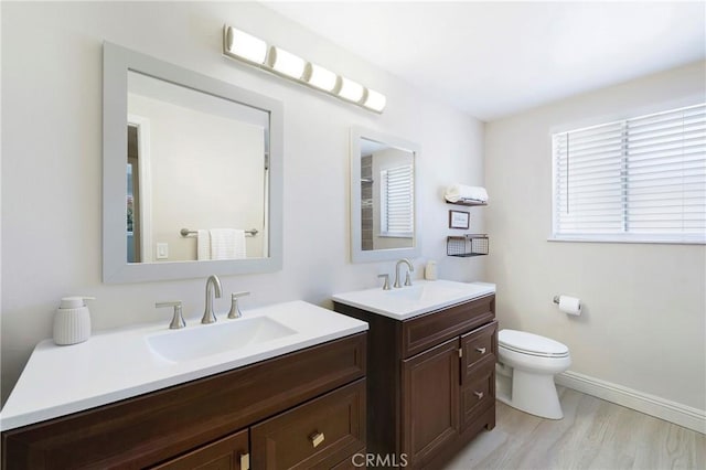 21848 Ute Way, Lake Forest, CA 92630 - full bath with two vanities, toilet, wood finished floors, and baseboards
