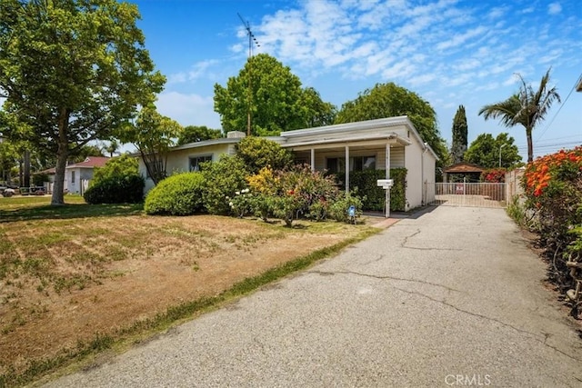 13411 Wingo St, Arleta, CA 91331 - view of front facade with a gate, asphalt driveway, and stucco siding