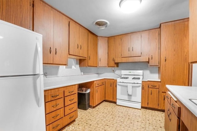 13411 Wingo St, Arleta, CA 91331 - kitchen featuring white appliances, light countertops, light flooring, and brown cabinetry