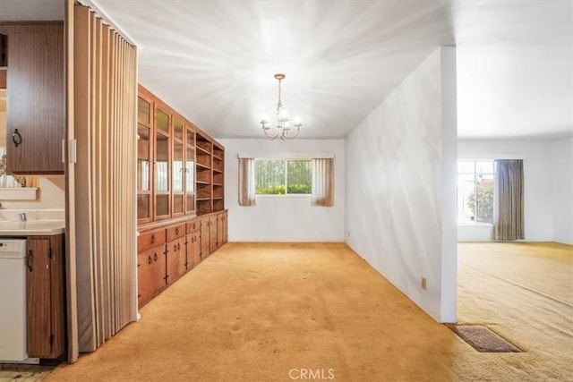 13411 Wingo St, Arleta, CA 91331 - unfurnished dining area with light colored carpet and a chandelier