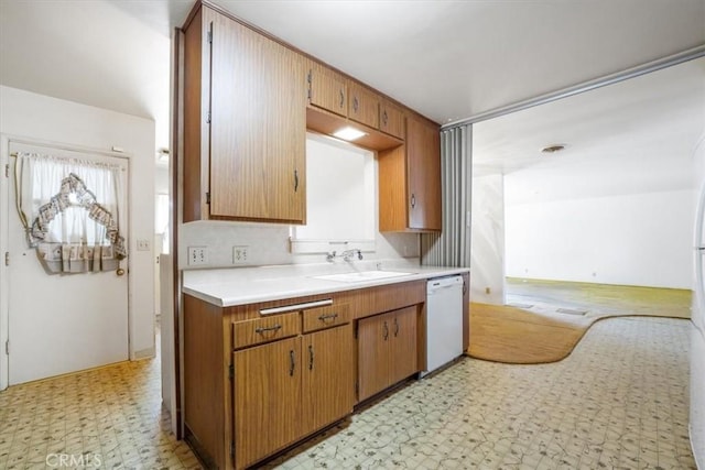 13411 Wingo St, Arleta, CA 91331 - kitchen featuring a sink, light flooring, dishwasher, light countertops, and brown cabinets