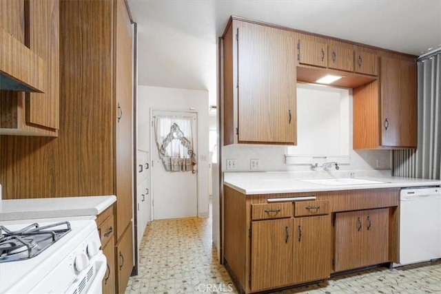 13411 Wingo St, Arleta, CA 91331 - kitchen with light flooring, a sink, white dishwasher, light countertops, and brown cabinets