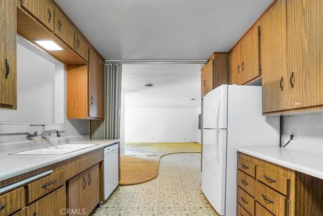 13411 Wingo St, Arleta, CA 91331 - kitchen with white appliances, a sink, light countertops, light flooring, and brown cabinetry