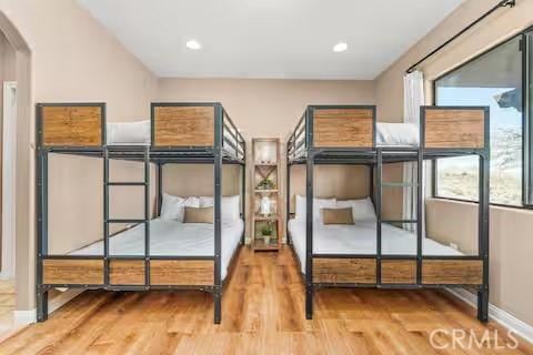 62398 Cope Ln, Joshua Tree, CA 92252 - bedroom featuring wood finished floors, arched walkways, and baseboards