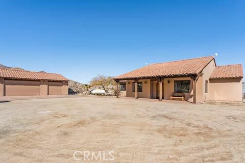 62398 Cope Ln, Joshua Tree, CA 92252 - rear view of house featuring a tiled roof and stucco siding