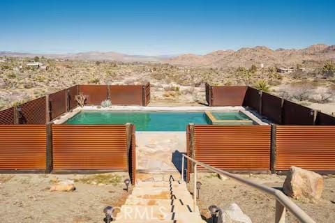 62398 Cope Ln, Joshua Tree, CA 92252 - view of pool with view of desert landscape, a mountain view, and a fenced backyard