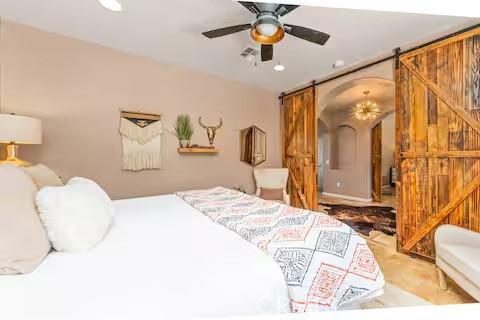 62398 Cope Ln, Joshua Tree, CA 92252 - bedroom featuring a barn door, recessed lighting, and ceiling fan