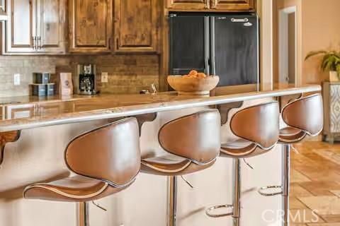 62398 Cope Ln, Joshua Tree, CA 92252 - bar featuring tasteful backsplash and freestanding refrigerator