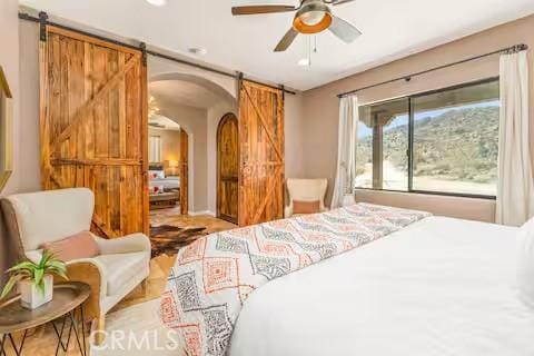 62398 Cope Ln, Joshua Tree, CA 92252 - bedroom with a barn door and arched walkways