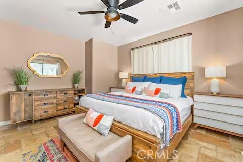 62398 Cope Ln, Joshua Tree, CA 92252 - bedroom featuring stone tile floors and a ceiling fan