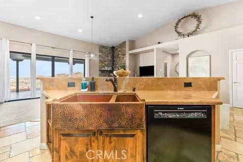 62398 Cope Ln, Joshua Tree, CA 92252 - kitchen with black dishwasher, open floor plan, a kitchen island with sink, light countertops, and a wood stove