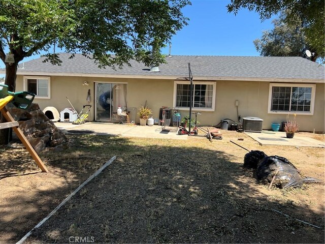 111 W Perry St, Perris, CA 92571 - back of property featuring cooling unit, stucco siding, a patio area, and roof with shingles