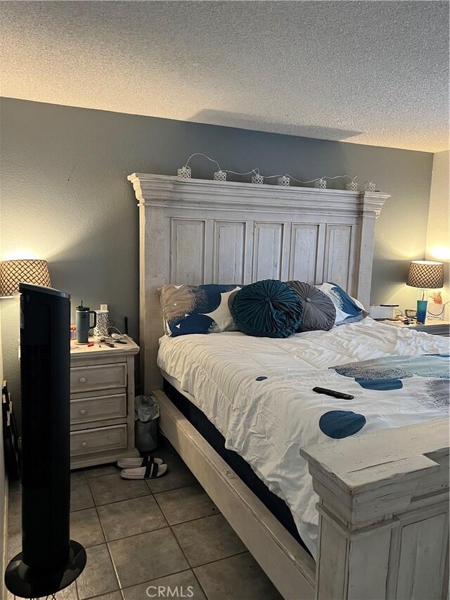111 W Perry St, Perris, CA 92571 - bedroom with a textured ceiling and dark tile patterned flooring