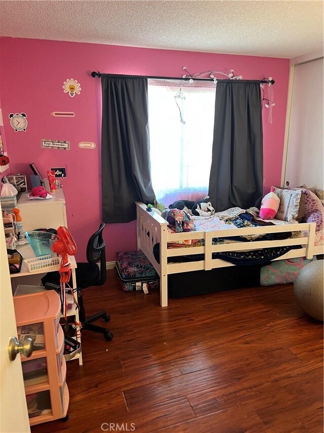 111 W Perry St, Perris, CA 92571 - bedroom with wood finished floors and a textured ceiling