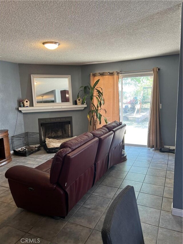 111 W Perry St, Perris, CA 92571 - tiled living area with a fireplace, a textured ceiling, and baseboards