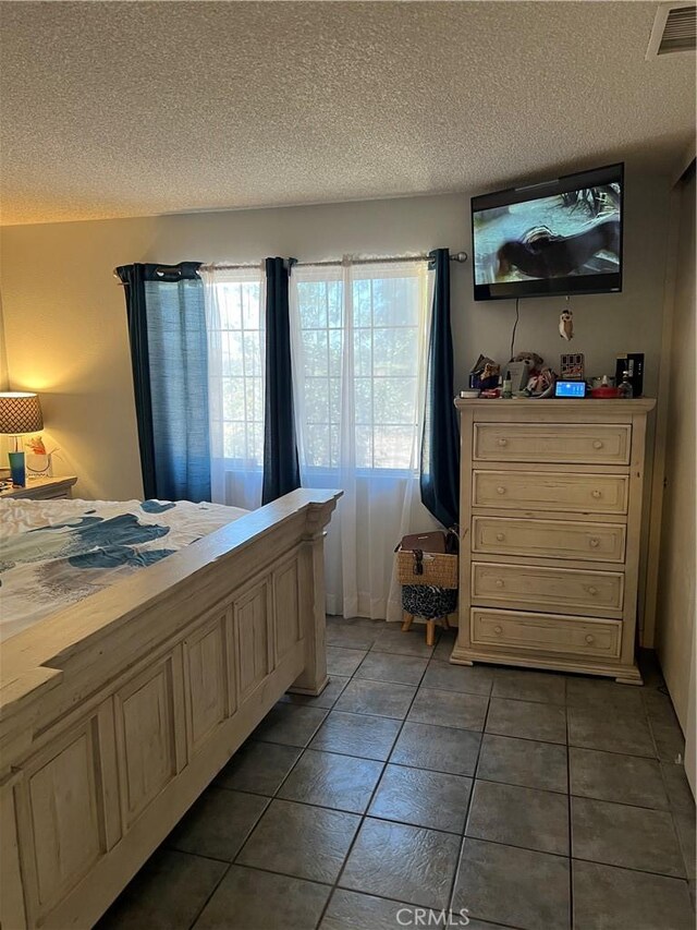 111 W Perry St, Perris, CA 92571 - tiled bedroom with a textured ceiling and multiple windows