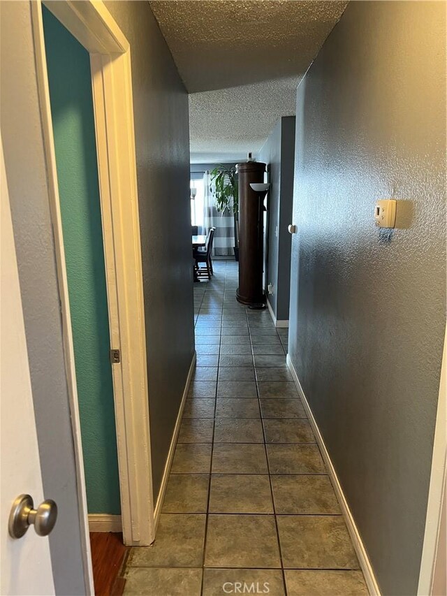 111 W Perry St, Perris, CA 92571 - hall featuring a textured ceiling, tile patterned floors, and baseboards