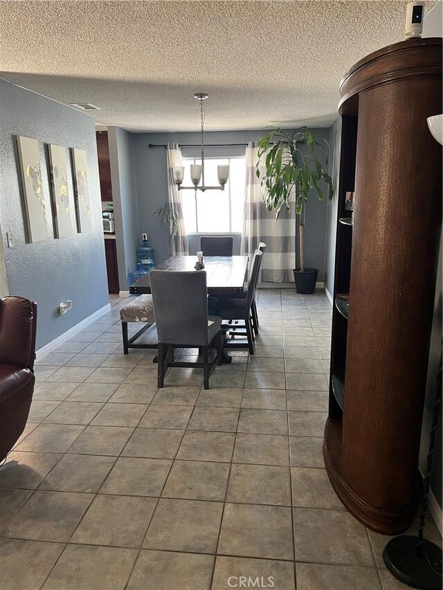 111 W Perry St, Perris, CA 92571 - tiled dining room with a textured ceiling and baseboards