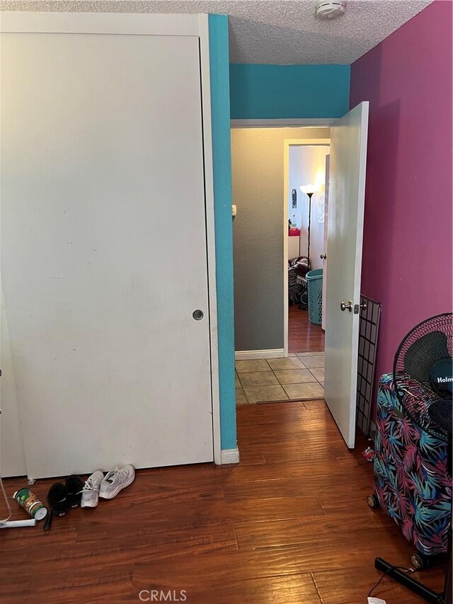 111 W Perry St, Perris, CA 92571 - corridor featuring wood finished floors and a textured ceiling