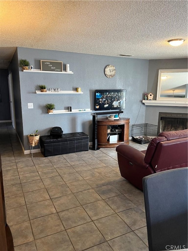 111 W Perry St, Perris, CA 92571 - living area featuring a textured ceiling, a fireplace, tile patterned floors, and a textured wall