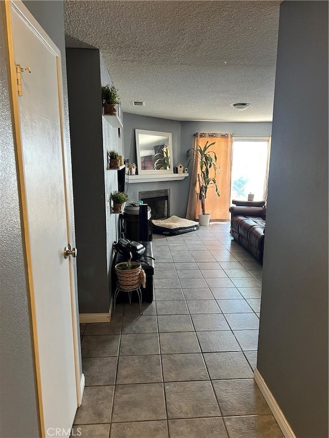 111 W Perry St, Perris, CA 92571 - hall featuring tile patterned flooring, a textured ceiling, and baseboards