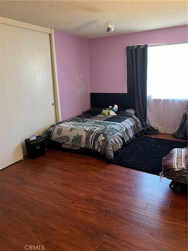 111 W Perry St, Perris, CA 92571 - bedroom featuring wood finished floors and a textured ceiling