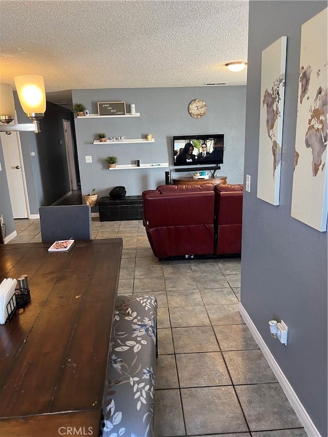 111 W Perry St, Perris, CA 92571 - tiled living room featuring a textured ceiling and baseboards