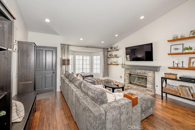 22206 Claibourne Ln, Saugus, CA 91350 - living area featuring lofted ceiling, a stone fireplace, wood finished floors, baseboards, and recessed lighting
