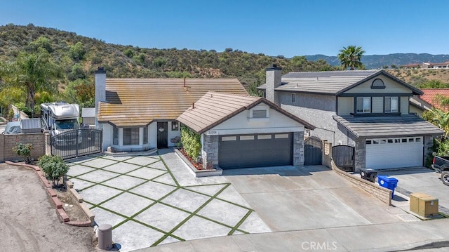 22206 Claibourne Ln, Saugus, CA 91350 - view of front of property featuring a gate, concrete driveway, and a chimney