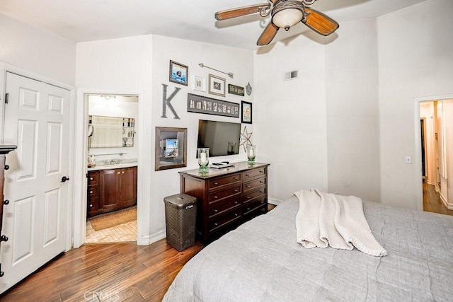 22206 Claibourne Ln, Saugus, CA 91350 - bedroom featuring wood finished floors, connected bathroom, a sink, a ceiling fan, and lofted ceiling