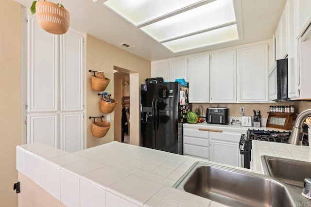 29495 Cara Way, Temecula, CA 92591 - kitchen with appliances with stainless steel finishes, tile counters, and white cabinets