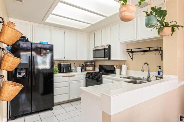 29495 Cara Way, Temecula, CA 92591 - kitchen with black appliances, a sink, tile countertops, light tile patterned floors, and a peninsula