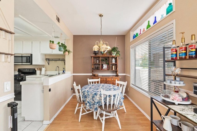 29495 Cara Way, Temecula, CA 92591 - dining room featuring light wood-type flooring, a chandelier, and baseboards