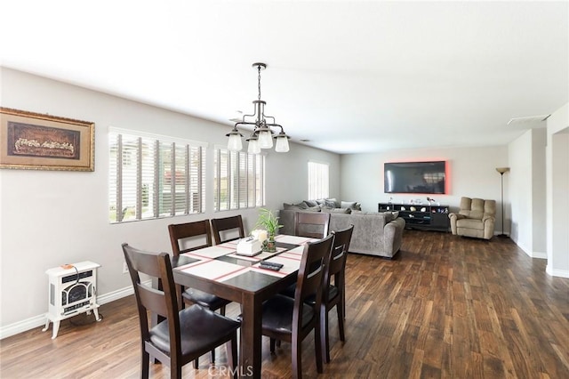 28926 Lavatera Ave, Murrieta, CA 92563 - dining space featuring a chandelier, dark wood-type flooring, and baseboards