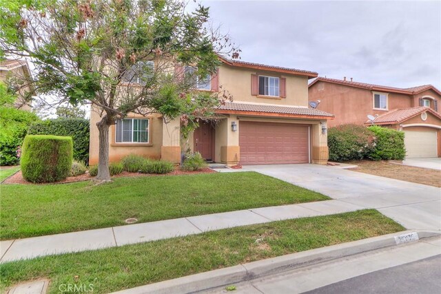 28926 Lavatera Ave, Murrieta, CA 92563 - mediterranean / spanish house featuring driveway, stucco siding, a front lawn, and an attached garage
