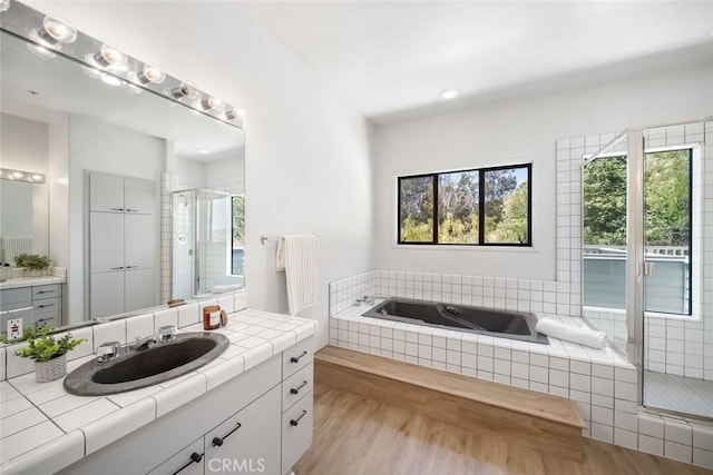667 Hill St, San Luis Obispo, CA 93405 - bathroom featuring a stall shower, a garden tub, vanity, and wood finished floors