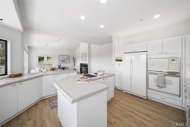 667 Hill St, San Luis Obispo, CA 93405 - kitchen featuring white appliances, light wood-type flooring, a kitchen island, white cabinetry, and recessed lighting