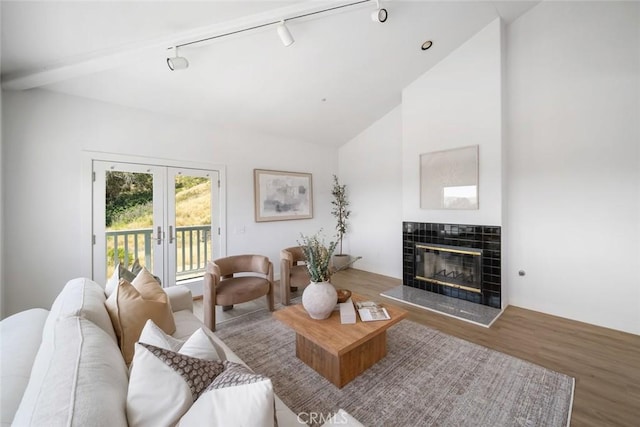 667 Hill St, San Luis Obispo, CA 93405 - living area featuring track lighting, a tile fireplace, wood finished floors, french doors, and vaulted ceiling