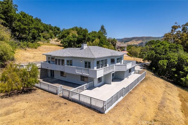 667 Hill St, San Luis Obispo, CA 93405 - rear view of property with a fenced backyard, a balcony, and a mountain view