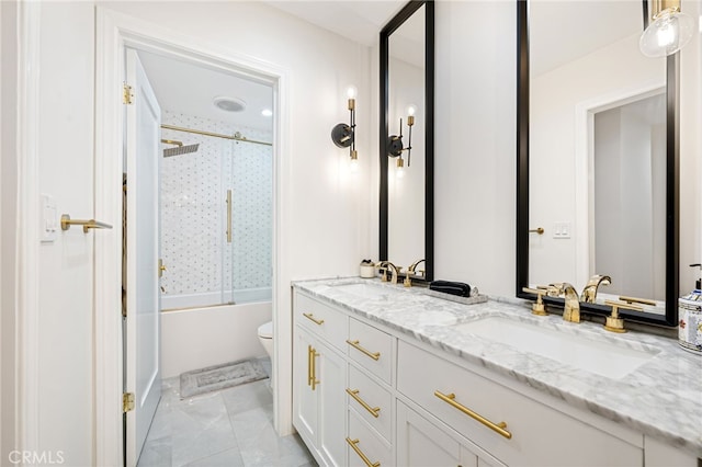 906 N Doheny Dr Unit 318, West Hollywood, CA 90069 - bathroom featuring toilet, double vanity, and shower / bath combination with glass door